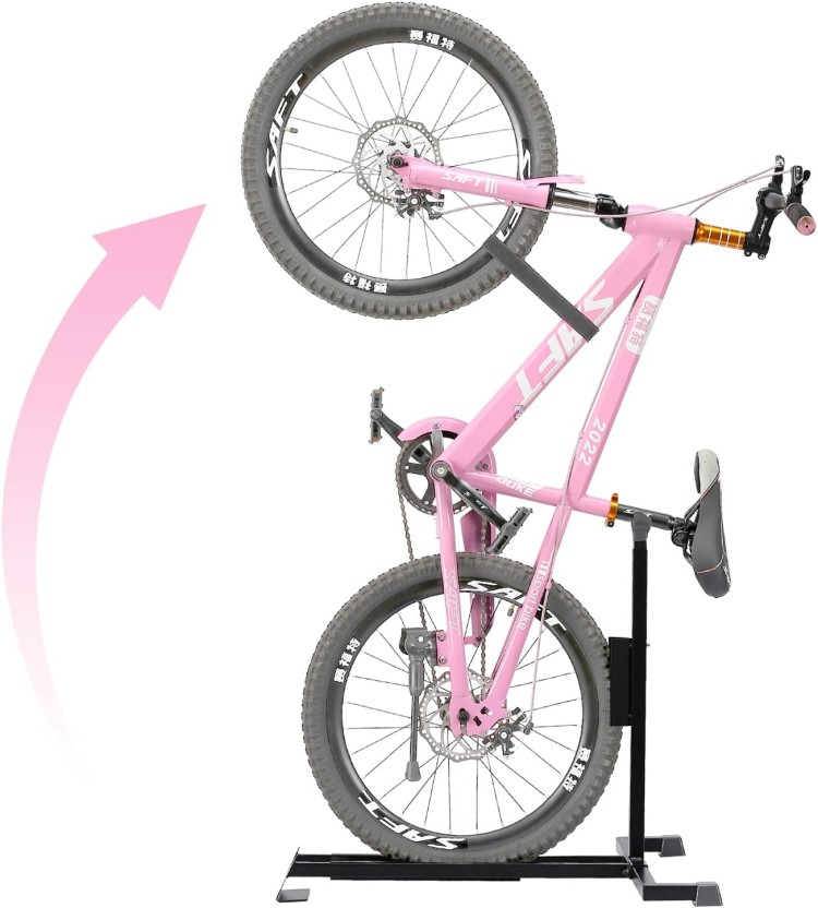 A pink bicycle on a stand with an arrow pointing up.