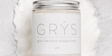 A white jar with the word greys on it.