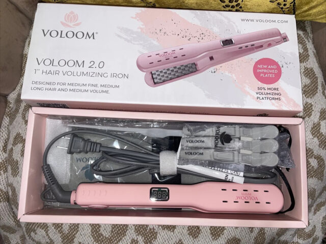 A pink hair straightener in a box.
