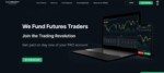 Website homepage of TakeProfit Trader featuring a laptop and smartphone displaying trading graphs, with text promoting financial services for futures traders.