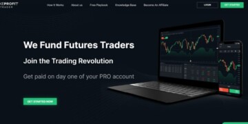 Image of a trading platform's website homepage displaying charts and graphs on a laptop and smartphone screen. Text on the image reads, "We Fund Futures Traders. Join the Trading Revolution. Get paid on day one of your PRO account.